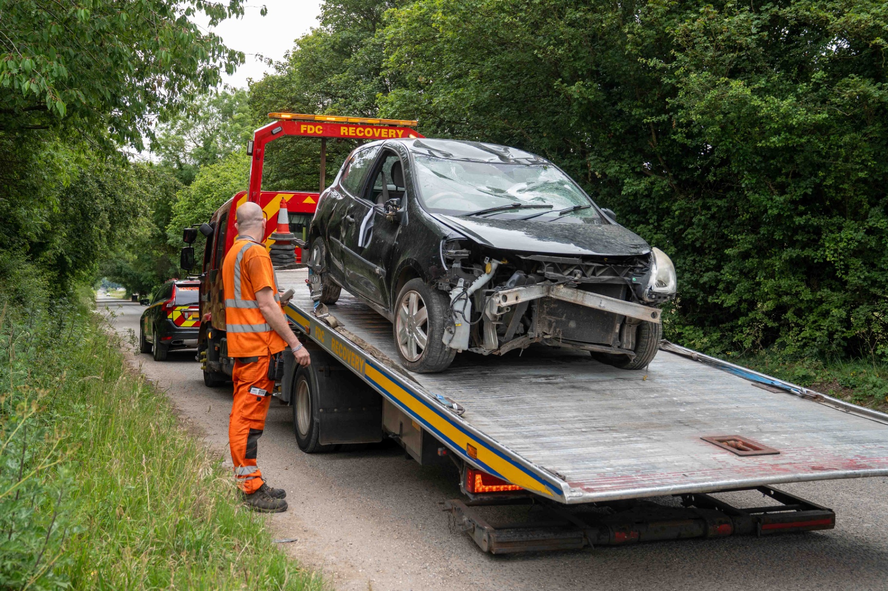Accident-damaged car loaded onto an FDC flatbed