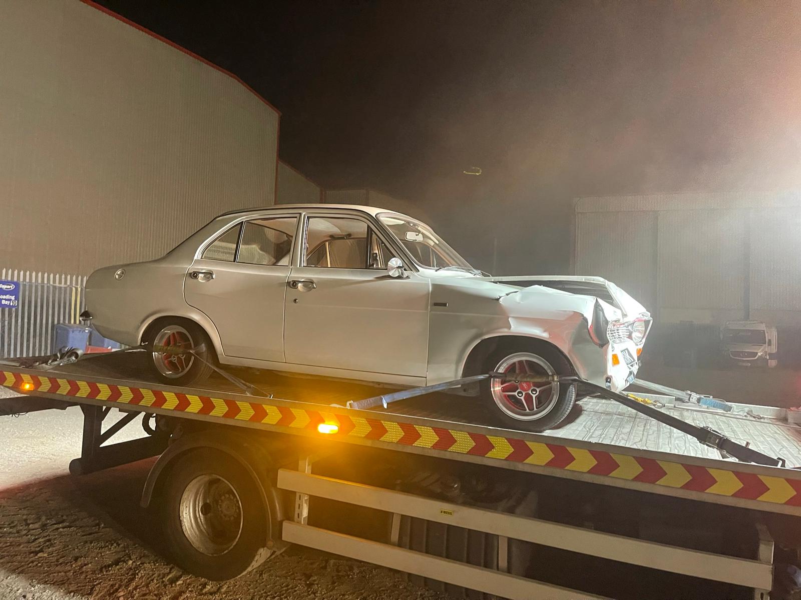 Classic saloon car recovered on an FDC flatbed at night