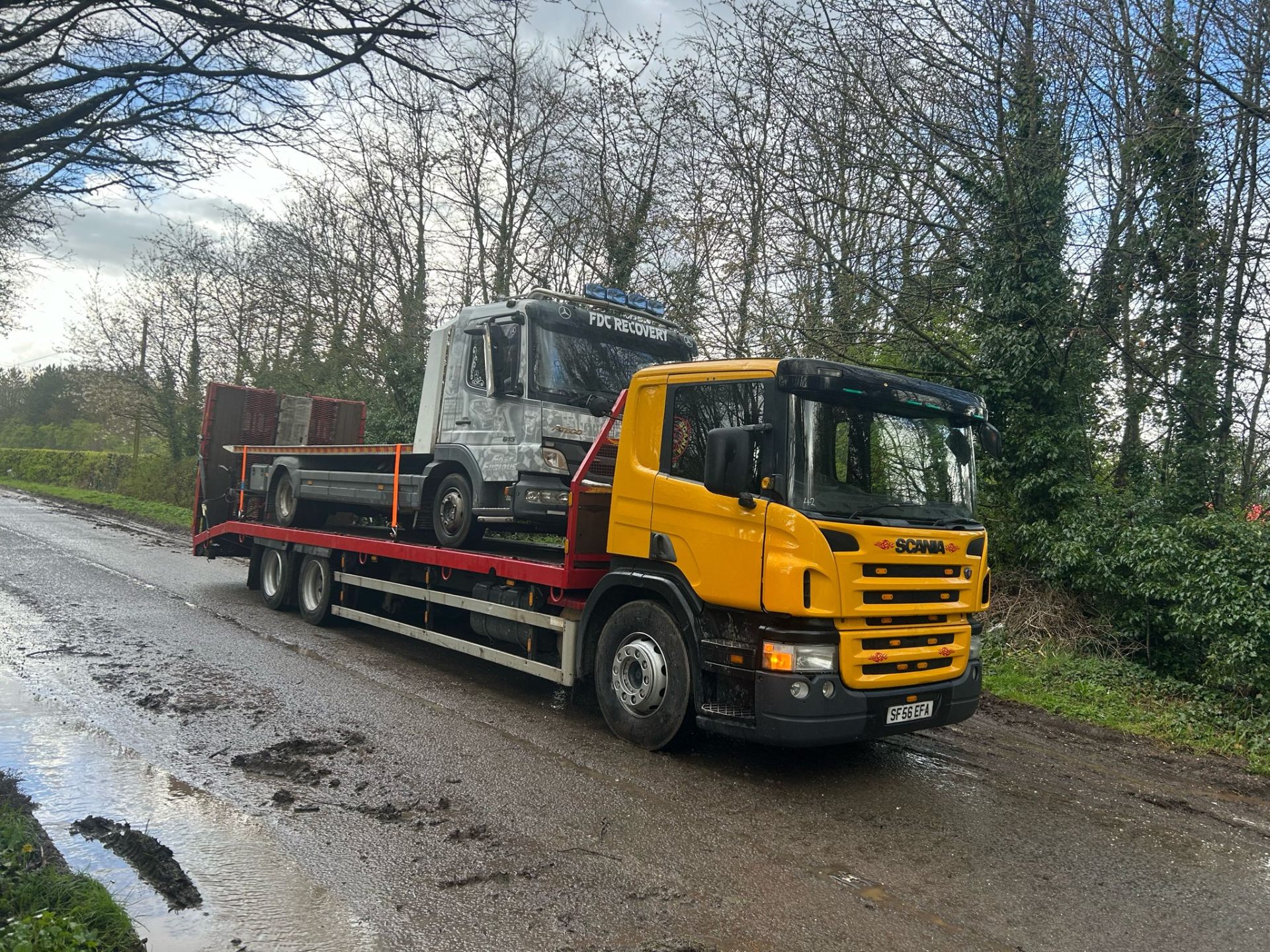 FDC Scania recovering a Mercedes Atego flatbed truck