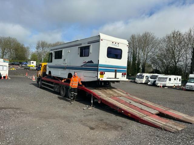 FDC crew loading a large Itasca motorhome onto the flatbed