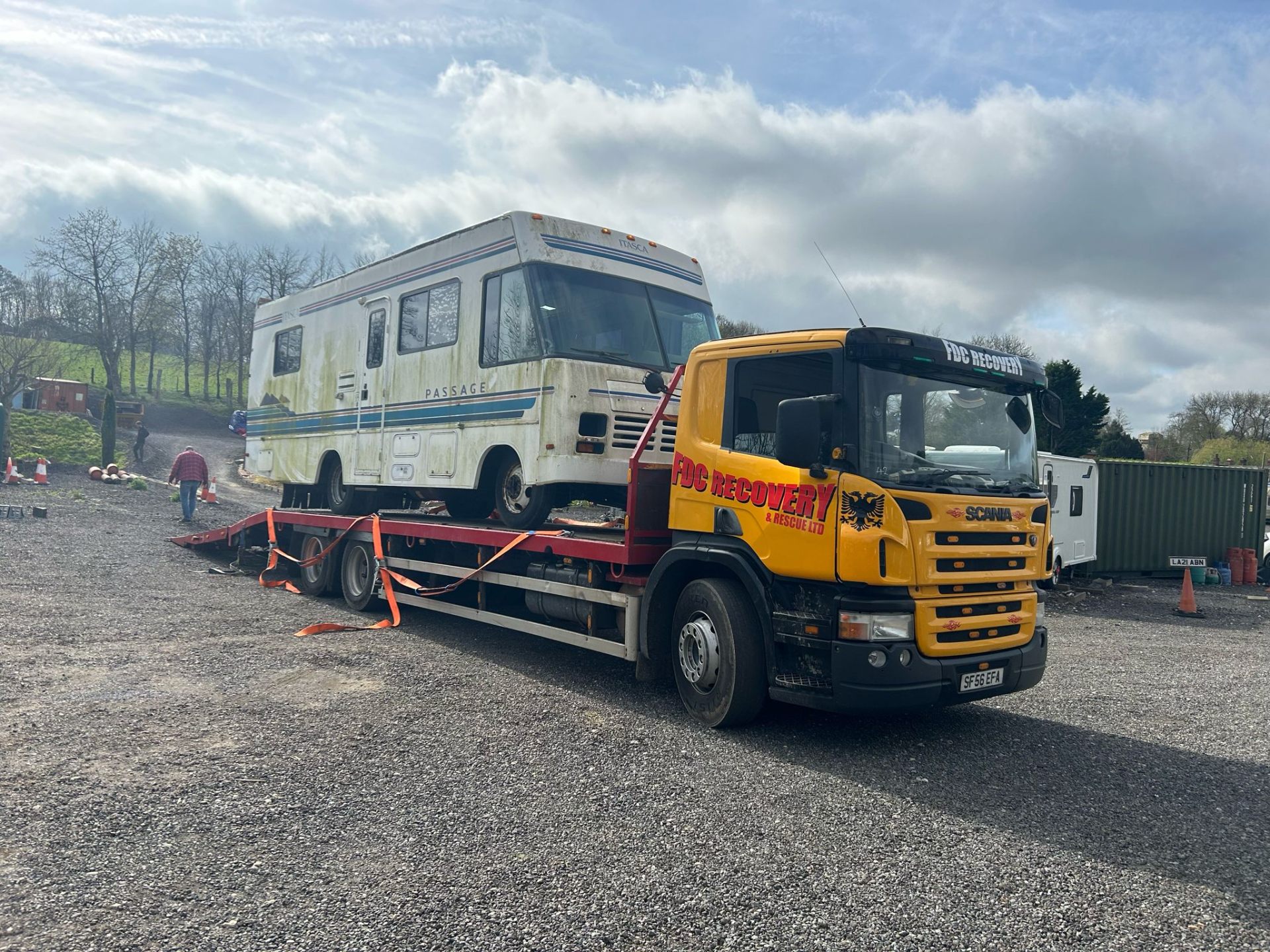 FDC Scania transporting a vintage Itasca Passage motorhome